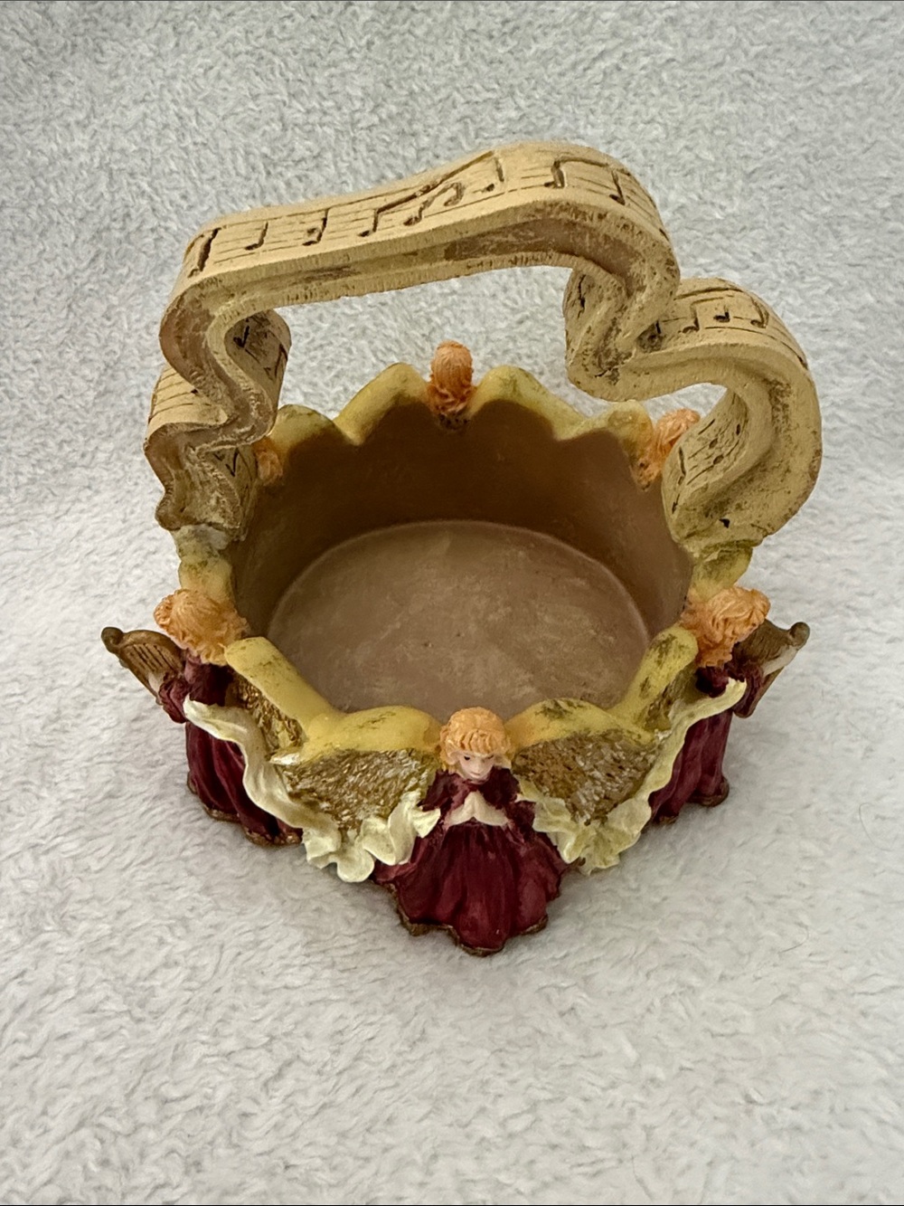Ornate Resin Angel Basket featuring musical notes and instruments